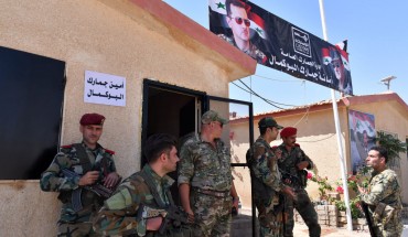 Members of the Syrian security forces gather at the border-crossing between Albu Kamal in Syria and Al-Qaim in Iraq, on the Syrian side in the eastern region of Deir Ezzor, on September 30, 2019. 