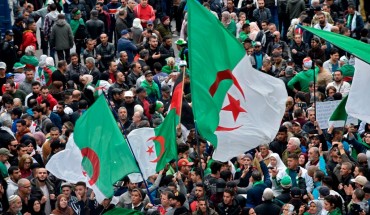 Algerian protesters wave national flags during an anti-government demonstration in the capital Algiers, on December 20, 2019. 