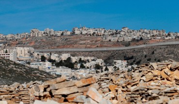 A picture taken on January 27, 2020 shows Israel's controversial concrete barrier (C) separating the Jewish settlement of Neve Yaakov (foreground) in the northern part of east Jerusalem and the Palestinian area of al-Ram (background) in the occupied West Bank. 