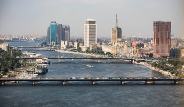 A complete overview of the Ramses Hilton Hotel (R), the Maspero Television Building (C) and the building of the Egyptian Ministry of Foreign Affairs with a view of the Qasr El Nil Bridge (front) on the banks of the Nile. 