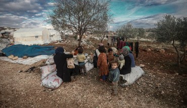 Syrian families, who have been forced to displace despite attacks carried out by Assad regime and Russia, sit on soil field despite the cold weather during winter season at Harbanush village in Idlib, Syria on December 28, 2019. 