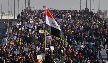 Iraqi students, waving national flags, join anti-government protests in the Shiite shrine city of Najaf in central Iraq on January 28, 2020.