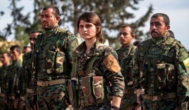 Fighters of the US-backed Kurdish-led Syrian Democratic Forces (SDF) take part in a parade to celebrate near the Omar oil field in the eastern Syrian Deir Ezzor province on March 23, 2019, after announcing the total elimination of the Islamic State (IS) group's last bastion in eastern Syria. 