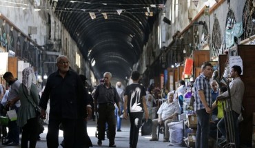 Shoppers walk through the Bzourieh market in the centre of the Syrian capital Damascus on September 11, 2019. 