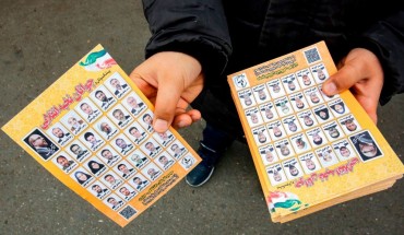 A man standing outside a mosque in the Iranian capital Tehran on February 14, 2020 hands out electoral leaflets showing candidates campaigning in the upcoming Iranian legislative election due to take place on February 21. (Photo by -/AFP via Getty Images)