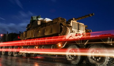  A Turkish military convoy of tanks and armoured vehicles passes through the city of Idlib, in northwestern Syria, near the Syria-Turkey border, late on February 7, 2020.