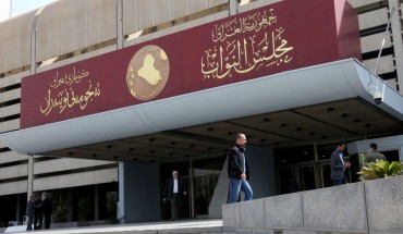 Iraqis stand outside parliament building, or Council of Representatives, in Baghdad's Green Zone on February 27, 2020. (Photo by SABAH ARAR / AFP) (Photo by SABAH ARAR/AFP via Getty Images)