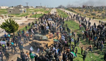 Syrians in protest climb atop a Turkish military M60T tank and infantry-fighting vehicle (IFV) as they attempt to block traffic on the M4 highway, which links the northern Syrian provinces of Aleppo and Latakia, before incoming joint Turkish and Russian military patrols (as per an earlier agreed upon ceasefire deal) in the village of al-Nayrab, about 14 kilometres southeast of the city of Idlib and seven kilometres west of Saraqib in northwestern Syria on March 15, 2020