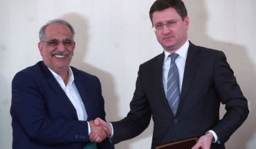 Iran's Minister of Economic Affairs and Finance, Masoud Karbasian (L) and Russias Energy Minister Alexander Novak shake hands at a signing ceremony following a meeting of the Russian-Iranian intergovernmental commission for trade and economic cooperation at Moscow's President Hotel