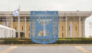 An emblem of Israel with the Knesset in the background, seen on the day of Israeli Legislative Elections 2020, in Central Jerusalem.