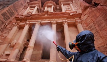 A labourer sprays disinfectant in Jordan's archaeological city of Petra south of the capital Amman on March 17, 2020, to prevent the spread of COVID-19. 