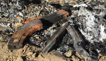 Damaged military gear is scattered on the ground at the site of an Islamic State (IS) group attack, a day earlier, on a unit of Iraq's Hashed al-Shaabi (Popular Mobilisation Forces) in Mukaishefah, about 180km (110 miles) north of the capital, on May 3, 2020. 