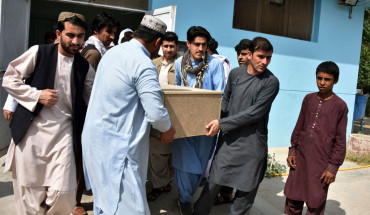 Relatives carry a coffin with the body of television journalist Nemat Rawan after he was shot dead by gunmen, in Kandahar Provicne on May 6, 2021.