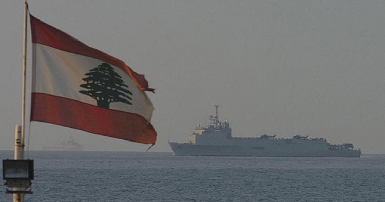 Lebanese flag waving over blue sea with ship