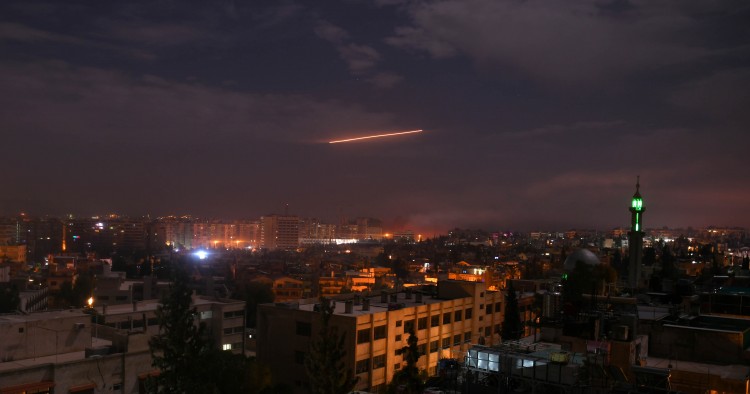 Syrian air defense batteries responding to Israeli missiles targeting Damascus