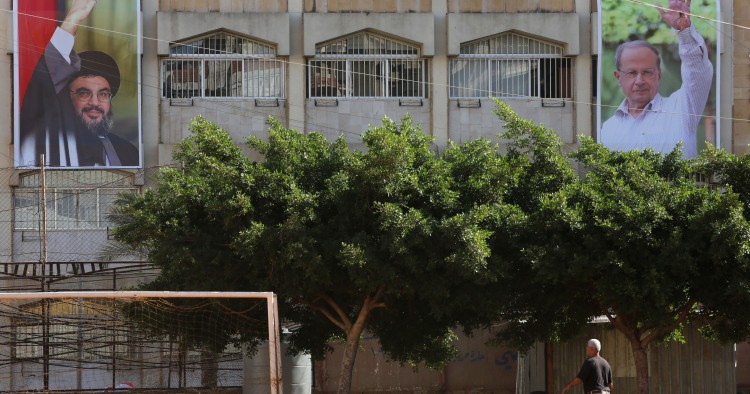 Posters of Hezbollah Shiite movement's leader Hassan Nasrallah (L) and of ex-army chief and leader of the Free Patriotic Movement party Michel Aoun, are seen in Aoun's hometown of Haret Hreik, a southern Beirut suburb, on October 31, 2016.