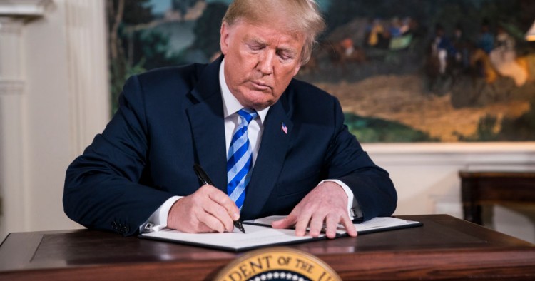 President Donald J. Trump signs a National Security Presidential Memorandum as he announces the withdrawal of the United States from the Iran nuclear deal during a 'Joint Comprehensive Plan of Action' event in the Diplomatic Reception Room of the White House on Tuesday, May 08, 2018 in Washington, DC.