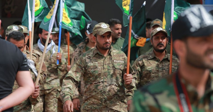 Members of the the predominantly Shia Muslim PMF take part in a PMF conference to honor Iranian fighters who died fighting ISIS