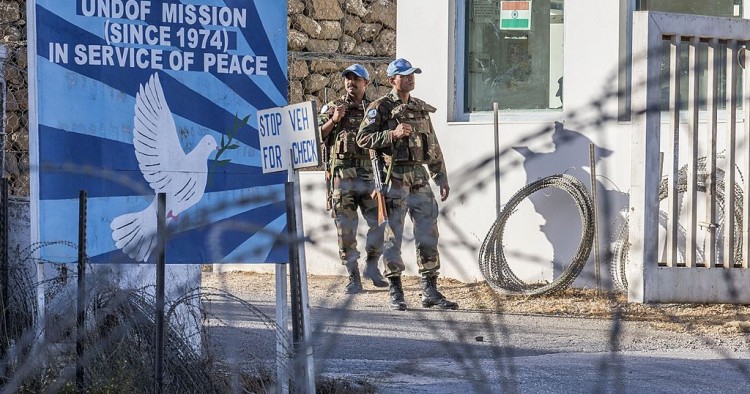 UNDOF forces stand guard at the entrance to the UN headquarters, in the demilitarized zone, near the Quneitra border crossing in the Israeli annexed Golan Heights on September 5, 2014
