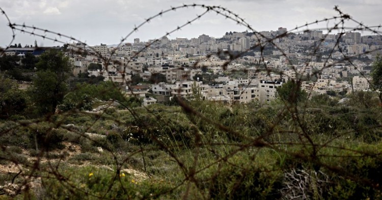 A picture taken from the Israeli settlement of Gilo in Jerusalem, shows the occupied West Bank city of Bethlehem behind barbed wire, on April 17, 2019..