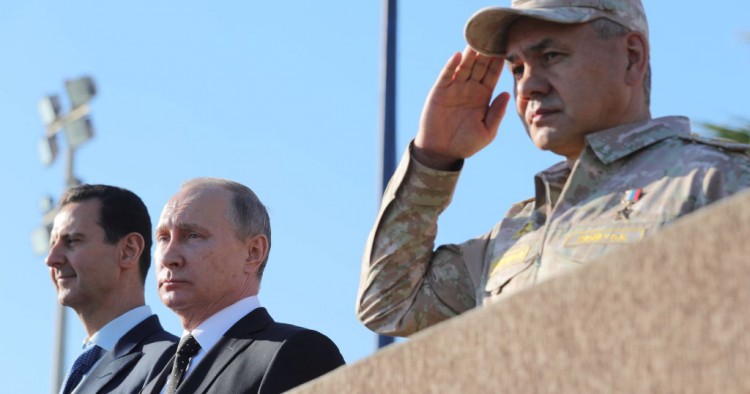 Syria's President Bashar al-Assad, Russia's President Vladimir Putin, and Russia's Defence Minister Sergei Shoigu (L-R) at the Russian Hmeimim air base.