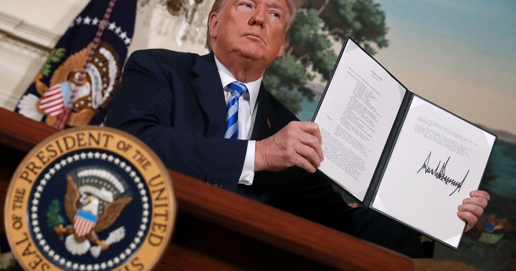 WASHINGTON, DC - MAY 08: U.S. President Donald Trump holds up a memorandum that reinstates sanctions on Iran after he announced his decision to withdraw the United States from the 2015 Iran nuclear deal in the Diplomatic Room at the White House May 8, 2018 in Washington, DC. After two and a half years of negotiations, Iran agreed in 2015 to end its nuclear program in exchange for Western countries, including the United States, lifting decades of economic sanctions. Since then international inspectors have n