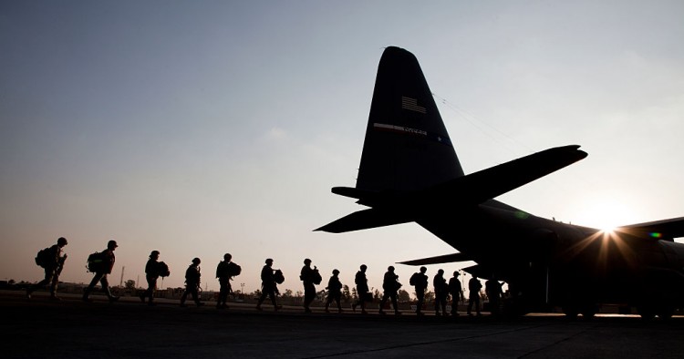 American soldiers board a US Airforce C130 at Baghdad Airport. 