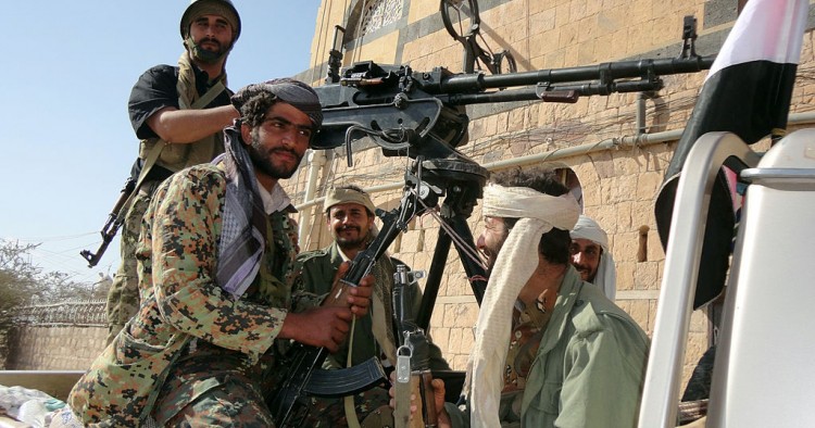 Supporters of al-Qaeda tote their rifles in the back of a pick-up truck in the town of Rada, 130 kilometres (85 miles) southeast of the capital Sanaa, on January 23, 2012.