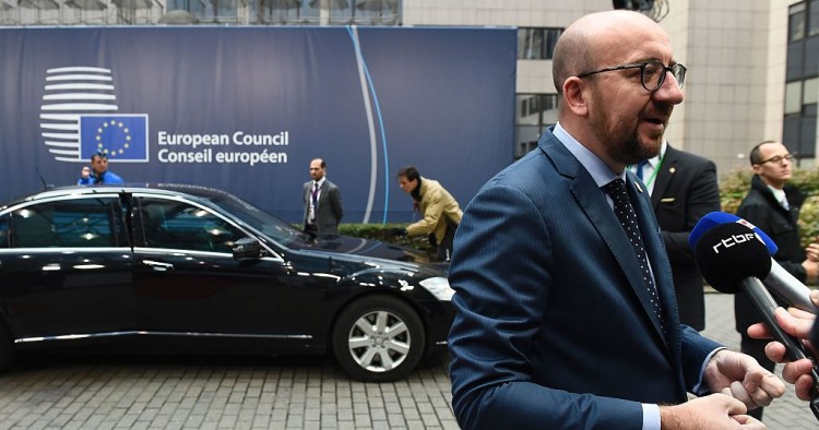 Belgium's Prime minister Charles Michel (R) addresses journalists as he arrives for the second day of an European Union leaders summit to discuss Syria, relations with Russia, trade and migration, on October 21, 2016 at the European Council, in Brussels