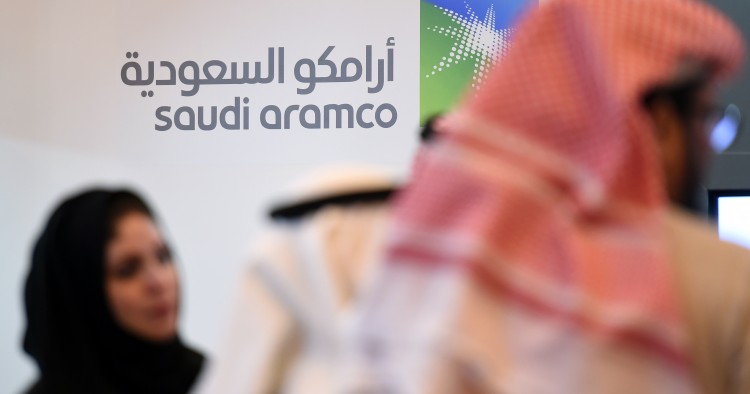 Saudi and Foreign investors stand in front of the logo of Saudi state oil giant Aramco during the 10th Global Competitiveness Forum on January 25, 2016, in the capital Riyadh. The an annual event brings together high-ranking Saudi officials and world business leaders. / AFP / Fayez Nureldine (Photo credit should read FAYEZ NURELDINE/AFP/Getty Images)