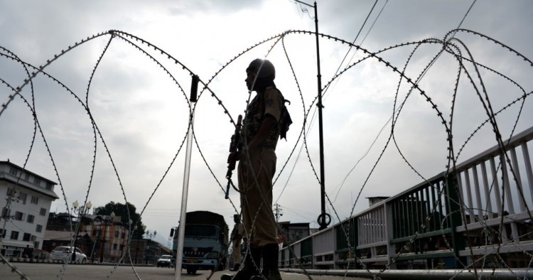 A security personnel stands guard on a street during a lockdown in Srinagar on August 11, 2019, after the Indian government stripped Jammu and Kashmir of its autonomy.