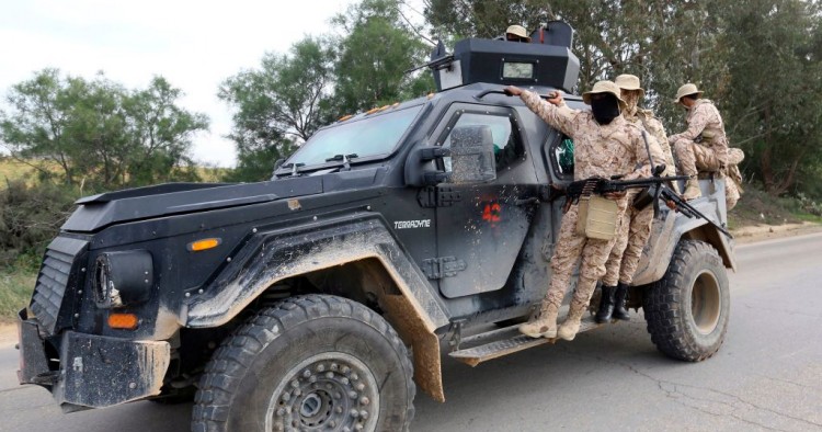 Members of the Tripoli Protection Force, an alliance of militias from the capital city, patrol an area south of the Libyan capital on January 18, 2019, during clashes with the Seventh Brigade group from the town of Tarhuna.