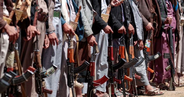 Yemeni men stand with Kalashikov assault rifles during a tribal meeting in the Huthi rebel-held capital Sanaa on September 21, 2019, as tribesmen donate rations and funds to fighters loyal to the Houthis along the fronts. 