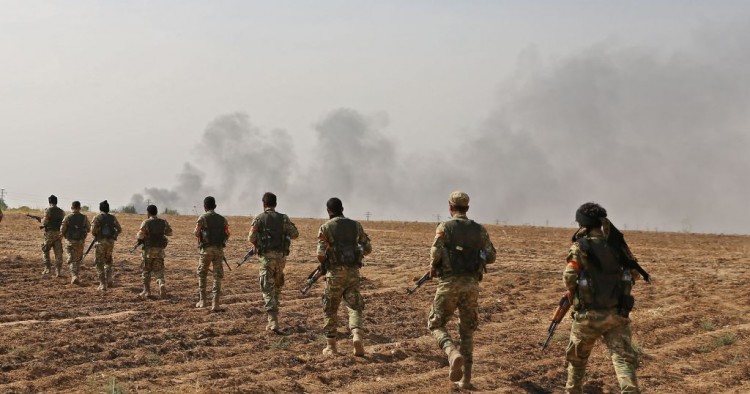 Pro-Turkish Syrian fighters cross the border into Syria as they take part in an offensive against Kurdish-controlled areas in northeastern Syria launched by the Turkish military, on October 11, 2019.