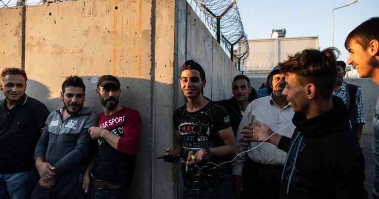 Syrian refugees wait in queue to enter to the Kahramanmaras refugee camp after coming from shopping on September 19, 2019 in Kahramanmaras, Turkey.