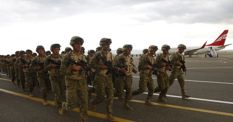 Georgian soldiers run during a farewell ceremony before their departure to Afghanistan in Tbilisi, June 27, 2013. 