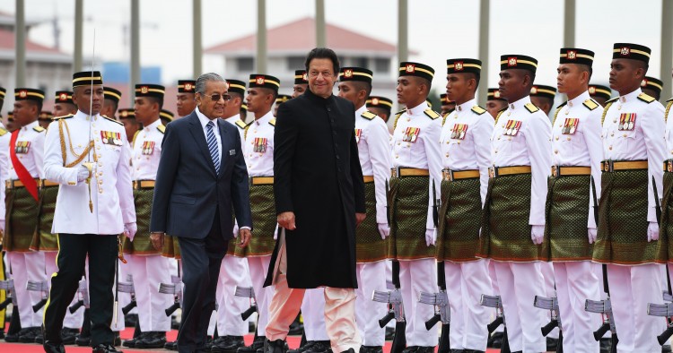Pakistan's Prime Minister Imran Khan (C) is accompanied by his Malaysian counterpart Mahathir Mohamad (L) as he reviews a guard of honour during a welcoming ceremony at the prime minister's office in Putrajaya on November 21, 2018. (Photo by Mohd RASFAN / AFP) (Photo credit should read MOHD RASFAN/AFP via Getty Images)
