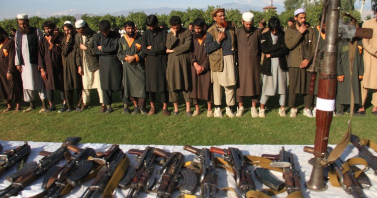 Member of the Islamic state ISIS militants stand alongside their weapons, as they surrendered to government in Jalalabad, Nangarhar, Afghanistan on November 17, 2019. 