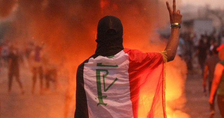 An Iraqi protester gestures the v-sign during a demonstration against state corruption, failing public services and unemployment at Tayaran square in Baghdad on October 2, 2019.