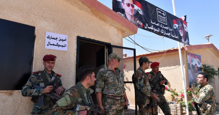 Members of the Syrian security forces gather at the border-crossing between Albu Kamal in Syria and Al-Qaim in Iraq, on the Syrian side in the eastern region of Deir Ezzor, on September 30, 2019. 