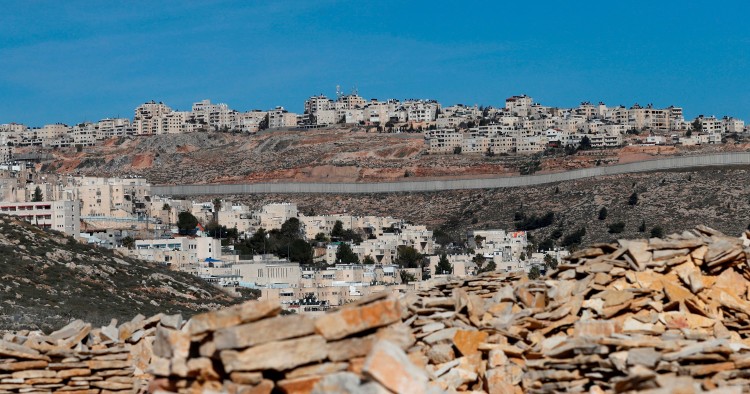 A picture taken on January 27, 2020 shows Israel's controversial concrete barrier (C) separating the Jewish settlement of Neve Yaakov (foreground) in the northern part of east Jerusalem and the Palestinian area of al-Ram (background) in the occupied West Bank. 