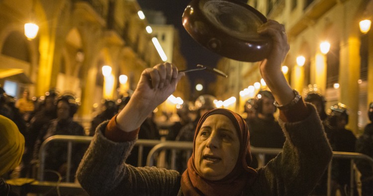 BEIRUT, LEBANON - JANUARY 16: An anti-government protester bangs a pan as they demonstrate ahead of the expected naming of a new cabinet tomorrow by Prime Minister Designate Hassan Diab, on January 16, 2020 in Beirut, Lebanon. "Diab has said he intends to field a cabinet of independent experts, but protesters see his designation as Prime Minister as an extension of the same political establishment they have been rallying against since unrest began last October 17th. (Photo by Sam Tarling/Getty Images)