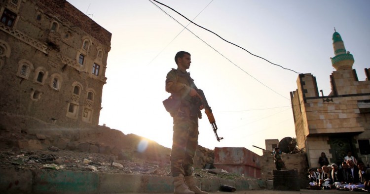 Yemeni security forces loyal to the Huthi-rebel government stands guard as Muslim worshippers perform Eid al-Fitr prayers at a square in the capital Sanaa on June 5, 2019, marking the end of the fasting month of Ramadan.