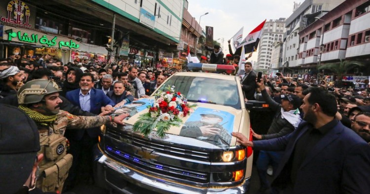 Mourners surround a car carrying the coffins of Iranian military commander Qasem Soleimani and Iraqi paramilitary chief Abu Mahdi al-Muhandis, killed in a US air strike, during their funeral procession in Kadhimiya, a Shiite pilgrimage district of Baghdad, on January 4, 2020. 