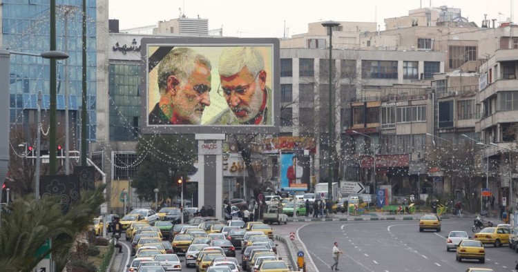 A billboard bearing a portrait with the black mourning ribbon of slain Iranian military commander Qasem Soleimani (L) and Iraqi paramilitary chief Abu Mahdi al-Muhandis hangs on a main road in the Iranian capital Tehran on January 4, 2020, one day after Soleimani and other members of the pro-Iranian Iraqi paramilitary group Al-Hashed Al-Shaabi were killed in a US air strike near Baghdad international airport. 