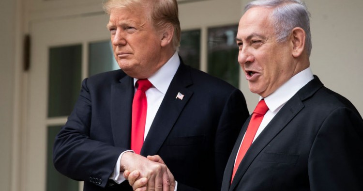 U.S. President Donald Trump and Prime Minister of Israel Benjamin Netanyahu shake hands while walking through the colonnade prior to an Oval Office meeting at the White House March 25, 2019 in Washington, DC. 
