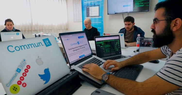 Engineers from the Israeli company "Commun.it" use their expertise in social media commercial analysis to identify networks of fake users, at their offices in the Israeli city of Bnei Brak near Tel Aviv on January 23, 2019.