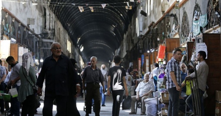 Shoppers walk through the Bzourieh market in the centre of the Syrian capital Damascus on September 11, 2019. 
