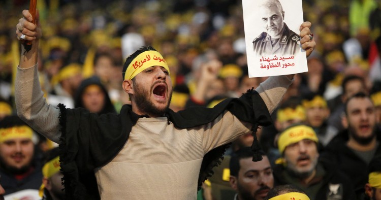 Supporters shout slogans during a rally for Qassem Soleimani in southern suburbs of Beirut, Lebanon, on Jan. 5, 2020. Hezbollah leader Sayyed Hassan Nasrallah urged on Sunday its fighters to attack U.S. soldiers in the region in retaliation for the assassination of Iranian top commander Qassem Soleimani by the United States. (Photo by Bilal Jawich/Xinhua via Getty) (Xinhua/ via Getty Images)