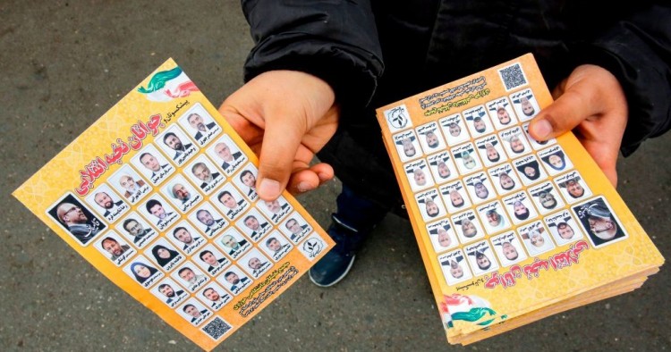 A man standing outside a mosque in the Iranian capital Tehran on February 14, 2020 hands out electoral leaflets showing candidates campaigning in the upcoming Iranian legislative election due to take place on February 21. (Photo by -/AFP via Getty Images)